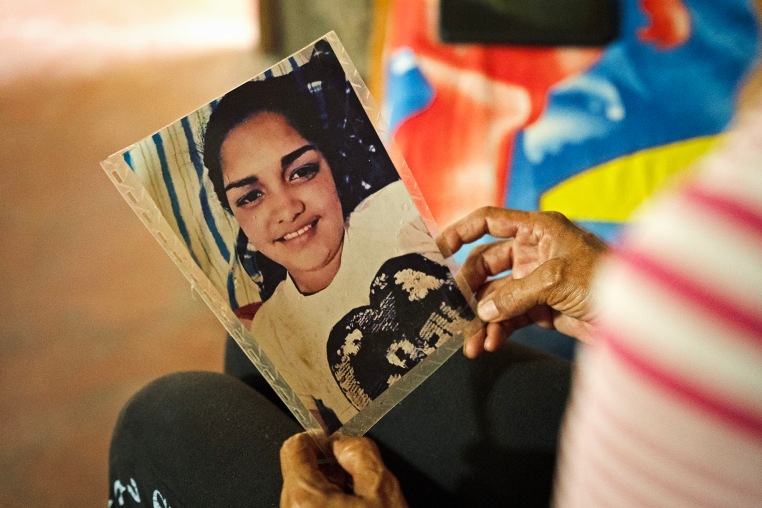 Aurimar Iturriago Villegas's mother looks at her photo at her home in Venezuela.